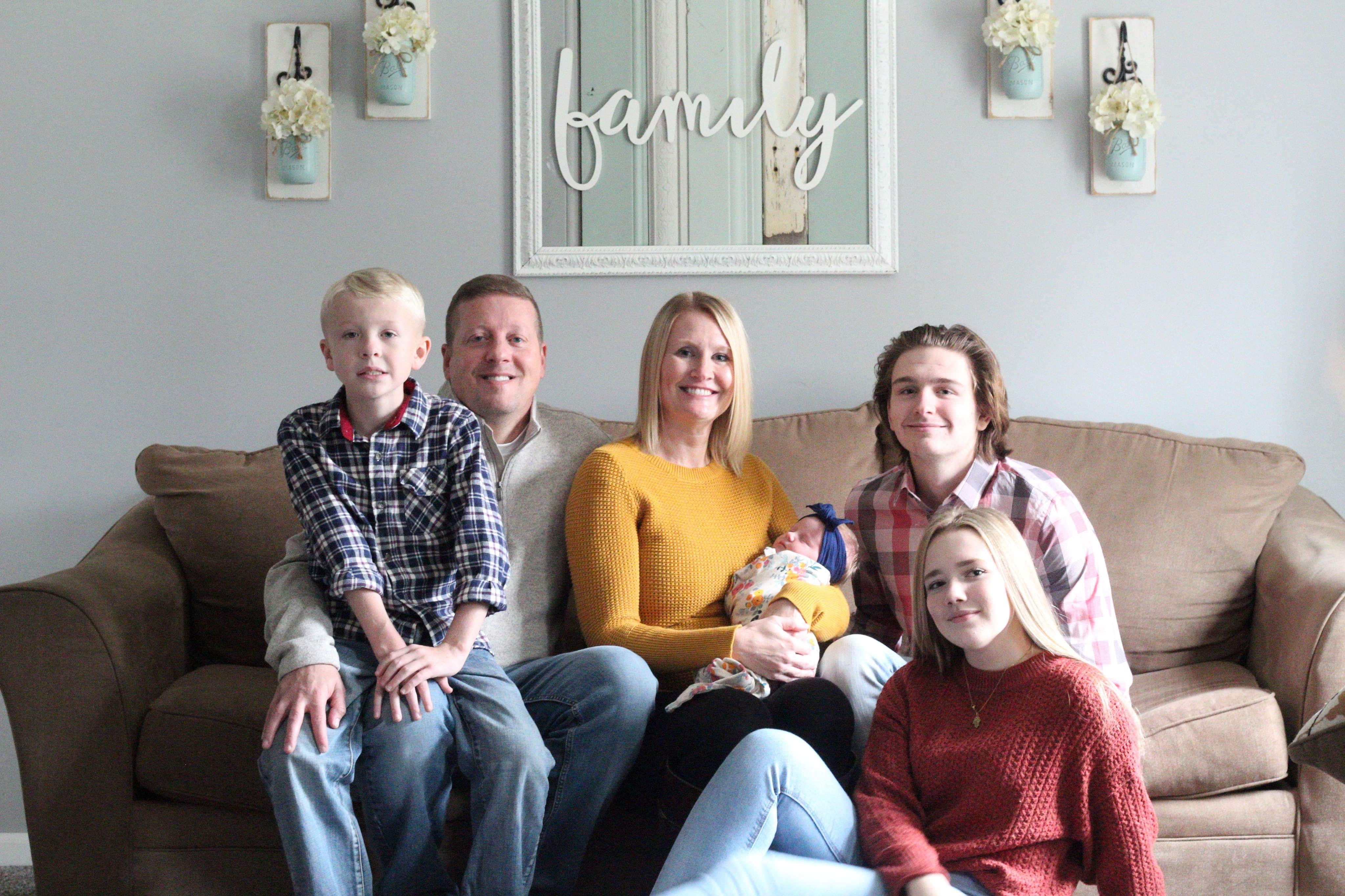 family sitting on couch in living room