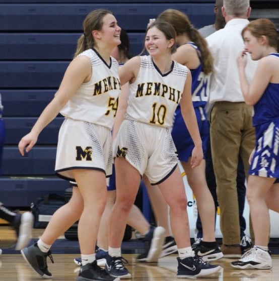 two girls smiling on basketball court