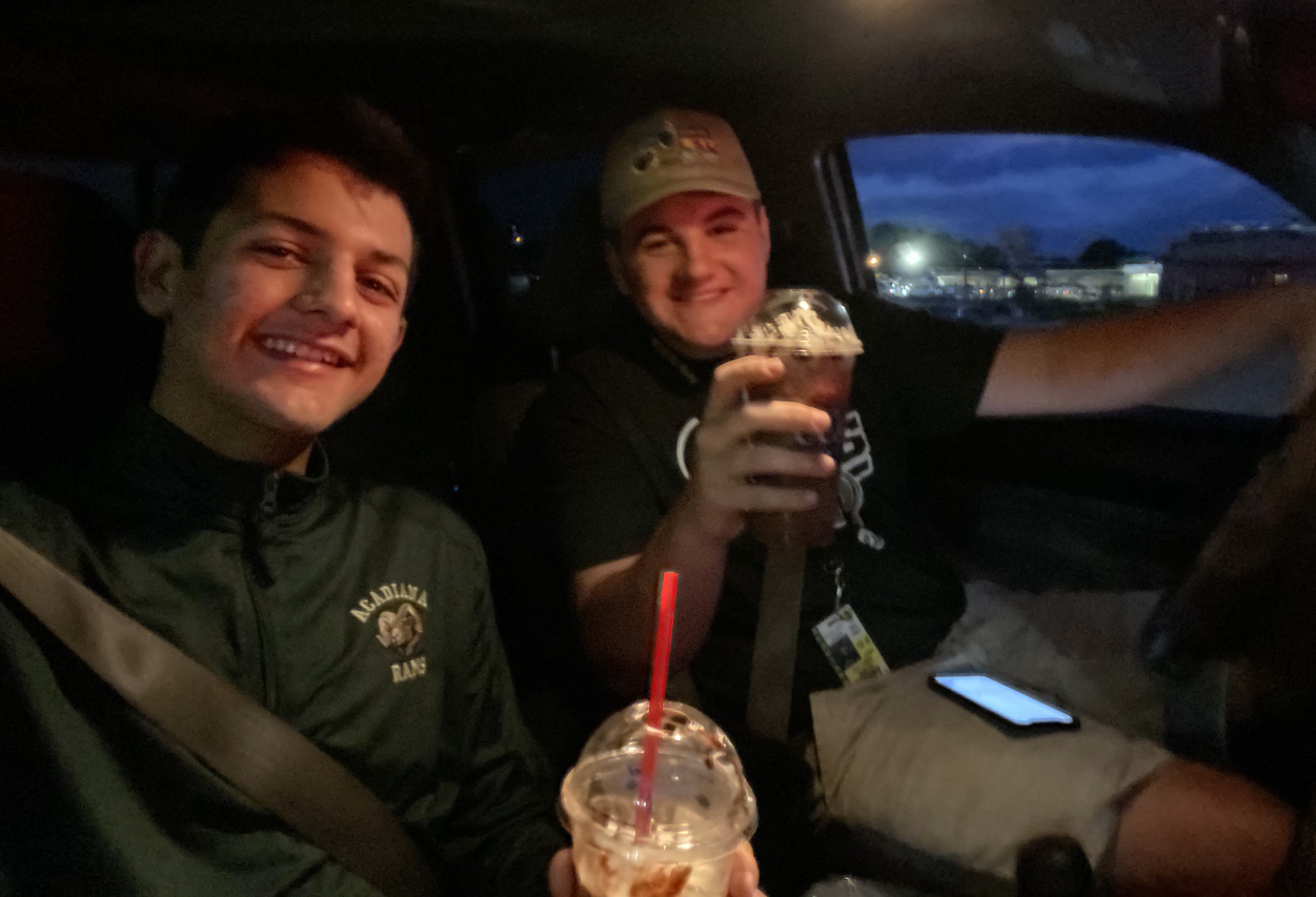 teen boy and dad in car getting coffee
