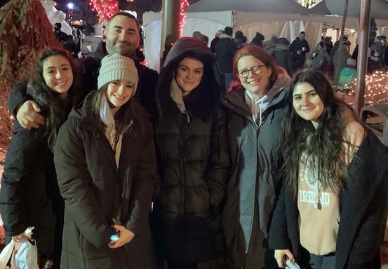 American family and Spanish exchange student posing for a family photo at Christmas