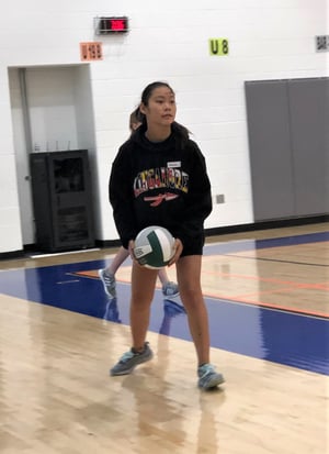 girl preparing to serve volleyball