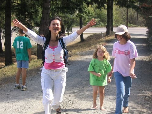 Korean teen running with arms raised