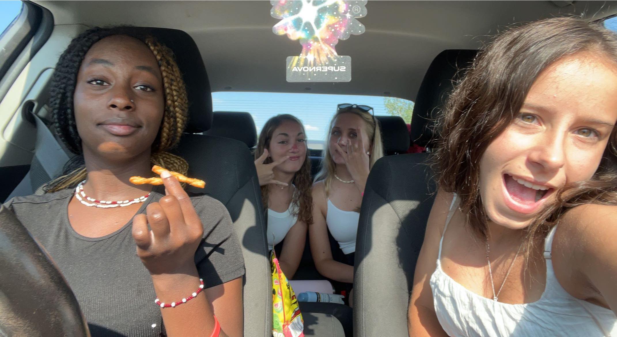 four teen girls in a car
