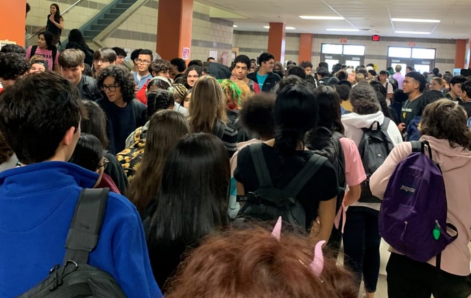 teens in crowded high school hallway