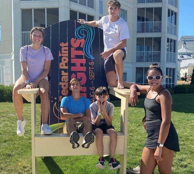 kids posing on a giant chair