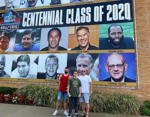 boys and host dad in front of Centenial Class of 2020 at NFL Hall of Fame