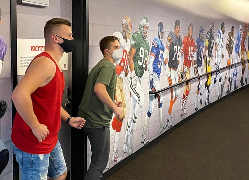 boys prentending to be part of football mural