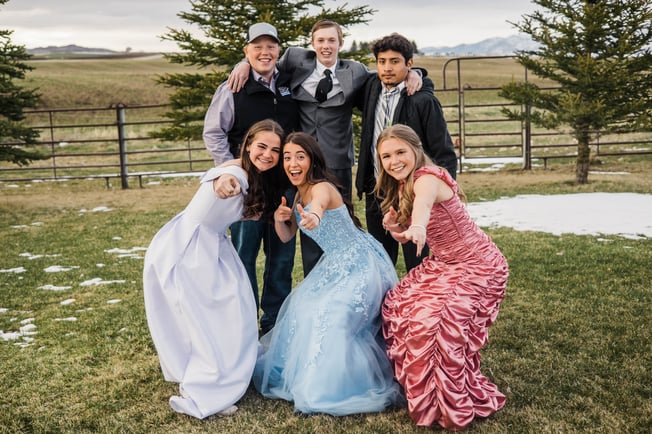 Paula posing with friends in formal dress