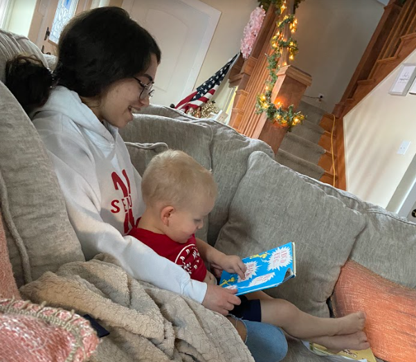 teen girl reading to toddler