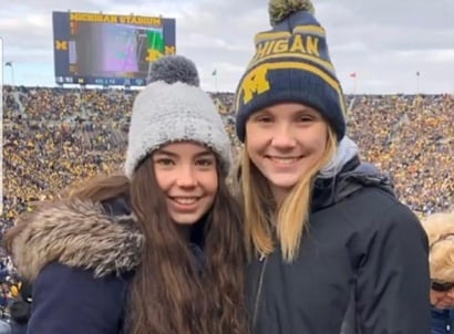 two teenage girls at University of Michigan football game