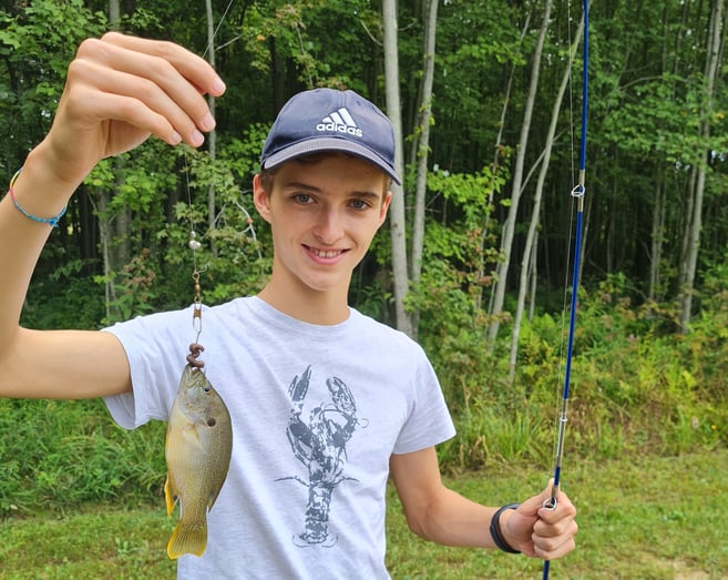 boy holding a fresh-caught fish