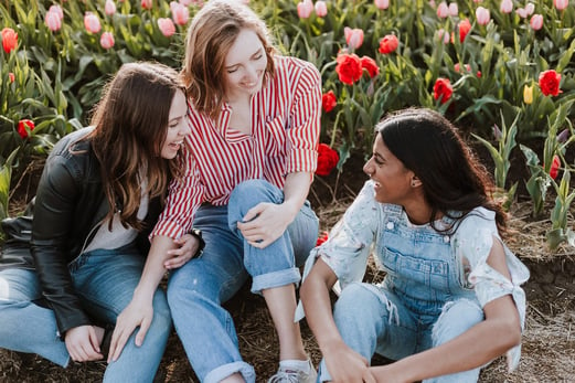 Three teen girls sitting and talking