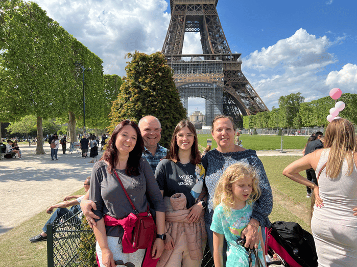 family in front of Eiffel Tower