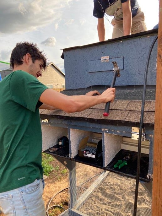 teen boy building chicken coop