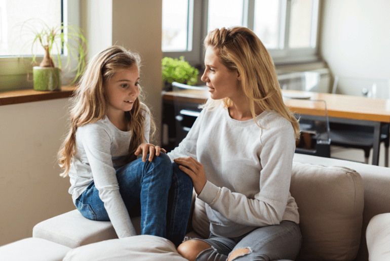 A mother talking to her young daughter