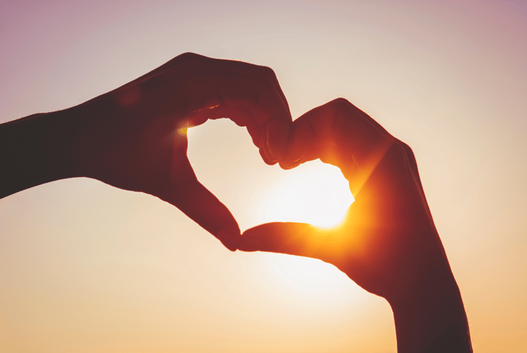 Two hands making a heart shape in the air