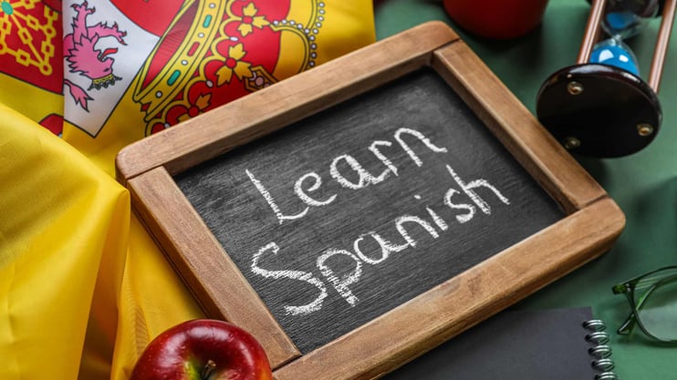 Spanish flag and blackboard that says Learn Spanish