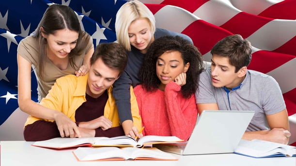 Students studying together with American flag in background
