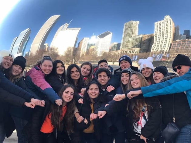 group of teens with Chicago in the background