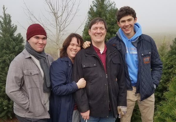 Thomas and host family with trees in the background