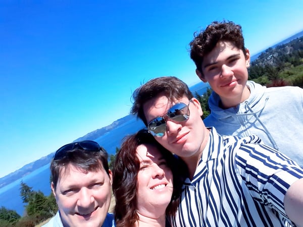 Thomas and host family with ocean in background