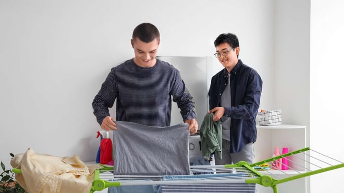 Two teenage boys doing laundry