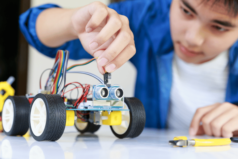 A high school boy building a robot