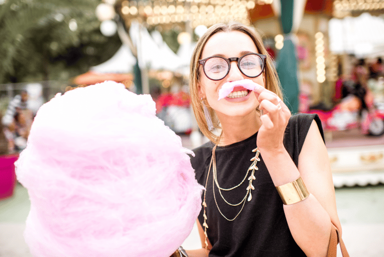 Girl at amusement park with cotton candy