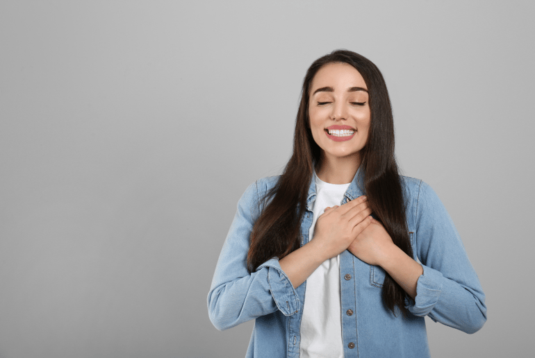 Girl holding her hands to her chest