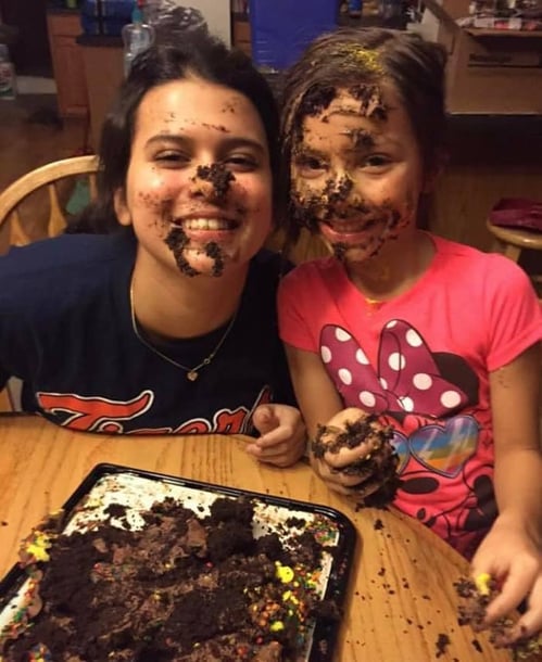 teen and young girl with dough on faces