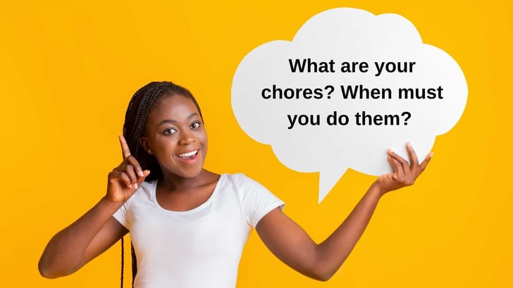 Young girl smiling and holding a speech bubble