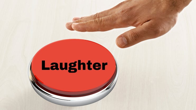 a hand hitting a laughter button