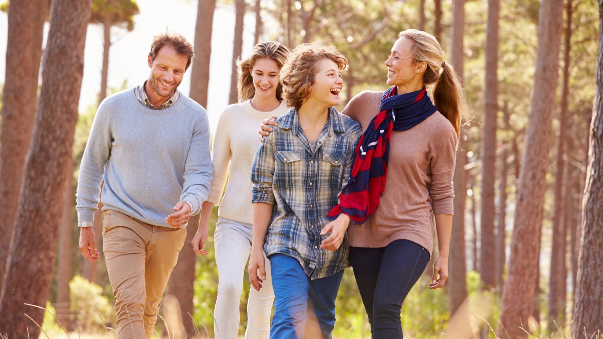 a happy family walking together in a wooded area