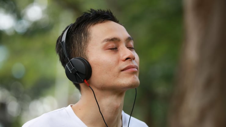 a teenage boy listening to music with headphones