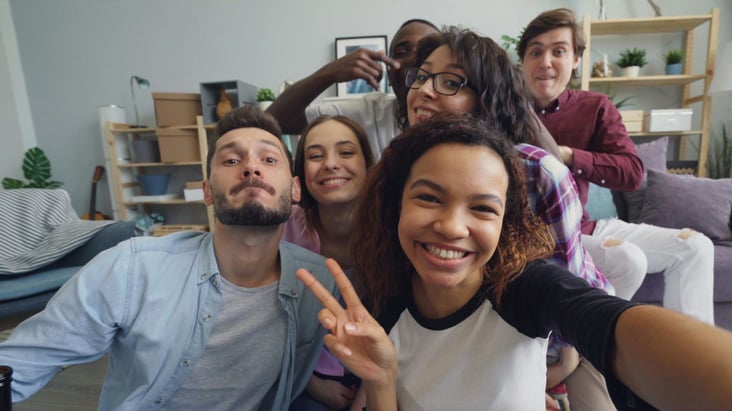 a teenage girl at the center of a fun family selfie
