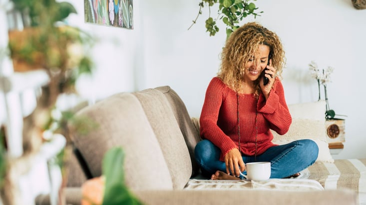 a woman talking on the phone and smilling