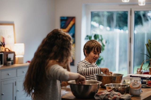 brother and sister cooking together in the kitchen