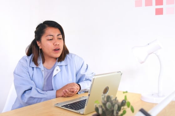 mother sitting in front of computer screen talking on a video call