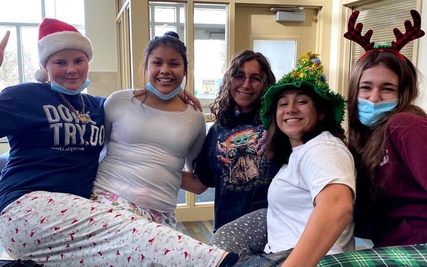 five teen girls in xmas pjs and hats