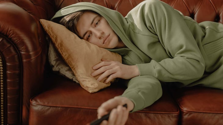 bored teen boy on sofa