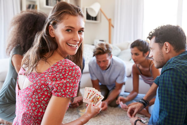 smiling girl playing cards