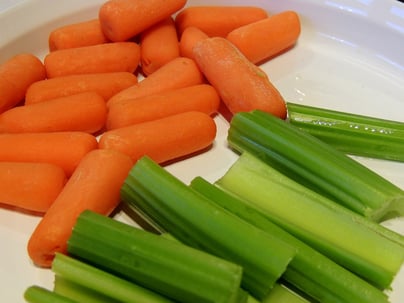 baby carrots and celery slices on a plate