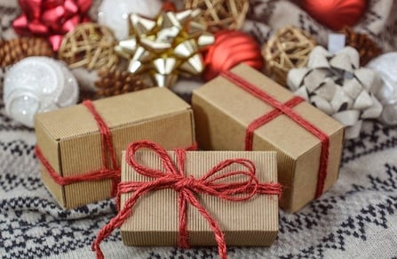 christmas packages wrapped in brown boxes with red string