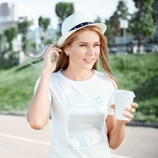woman walking and holding coffee