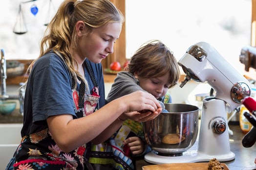 girl making cookies with child