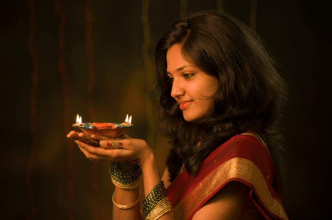 girl holding Dwali candle