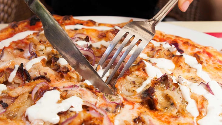 eating pizza with a fork and knife