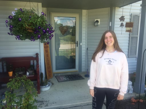 Exchange student from Spain standing in front of US host family home in Indianapolis