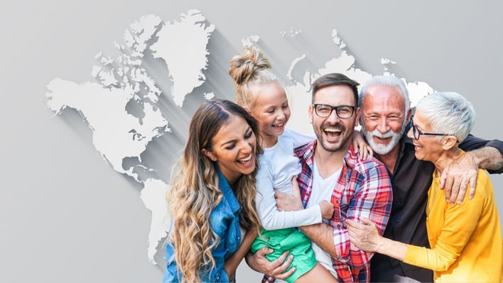 family in front of world map laughing happily