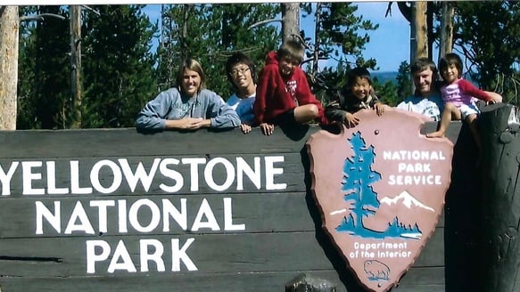 family photo with Yellowstone National Park sign